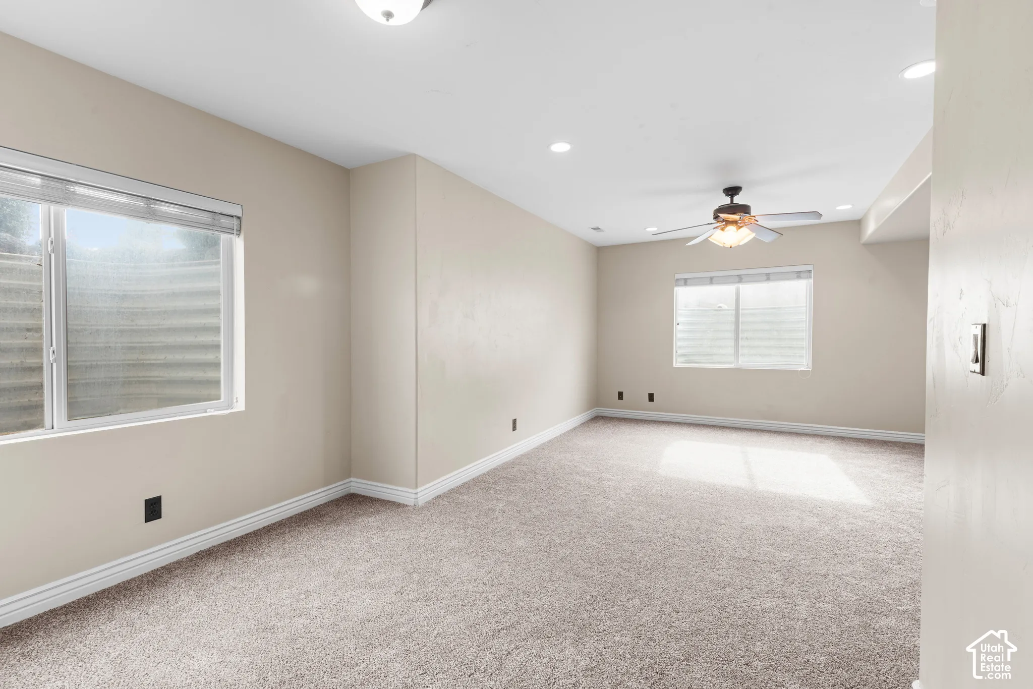 Recessed lighting, ceiling fan, and carpeted flooring