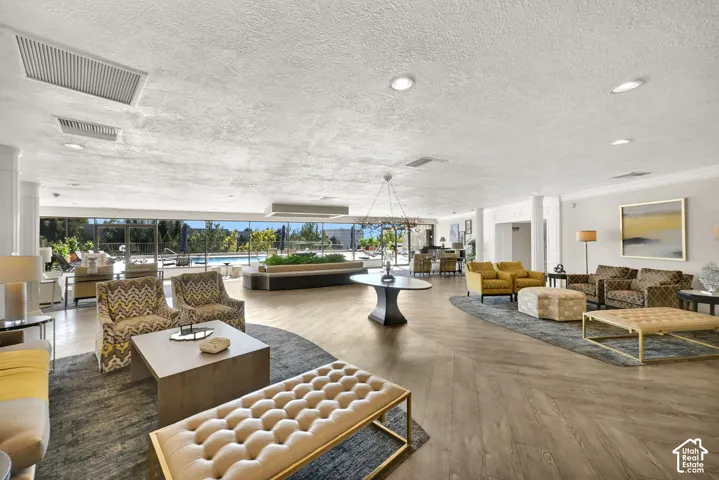Spacious common area featuring wood-finish flooring, recessed lighting, and expansive windows