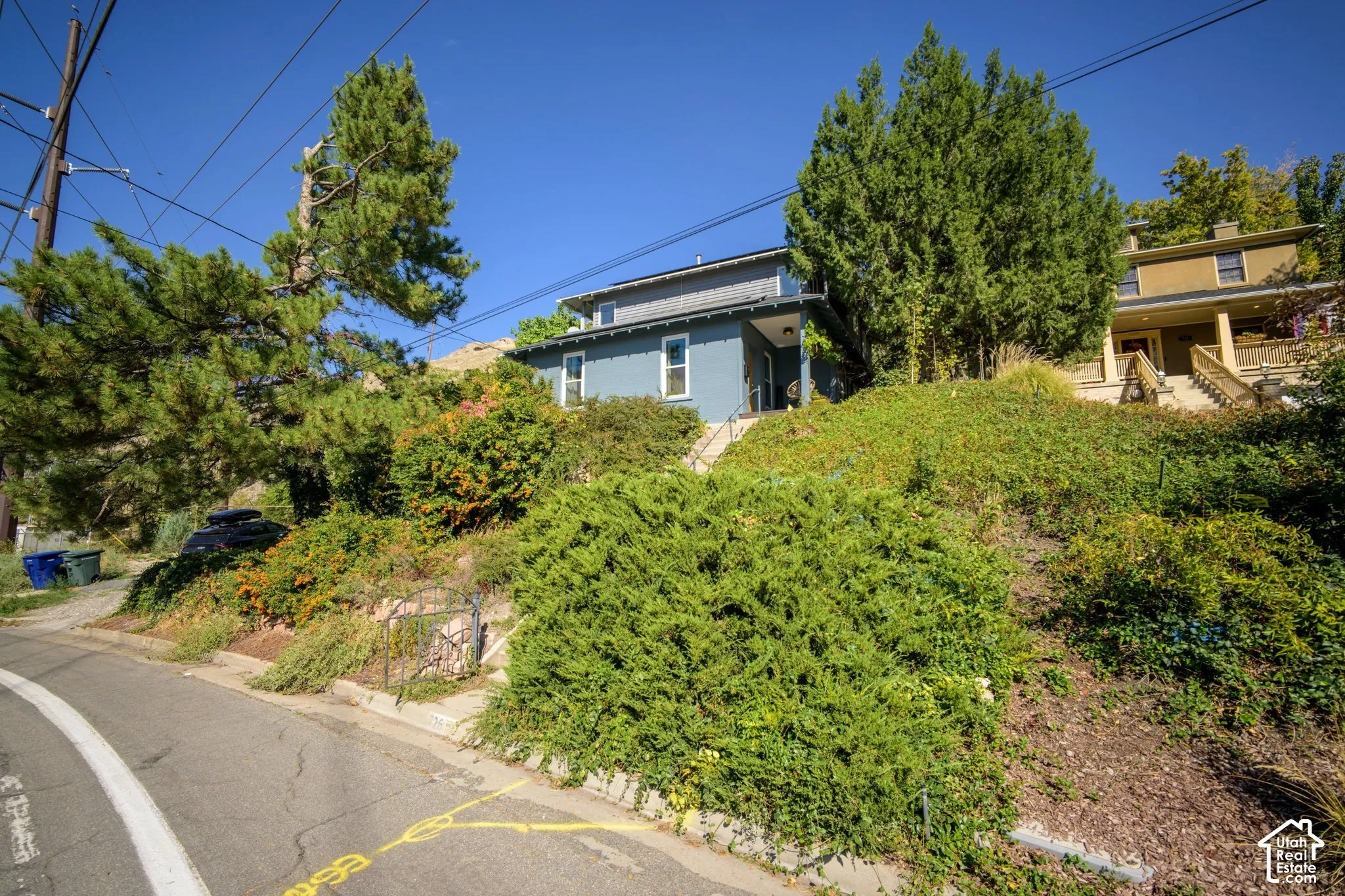 Blue exterior residence with a covered entry
