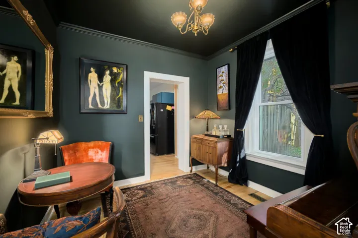 Hardwood flooring, chandelier lighting, and an expansive window