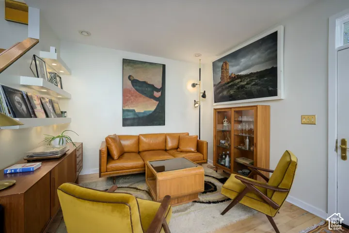 Light wood-finish flooring with white walls