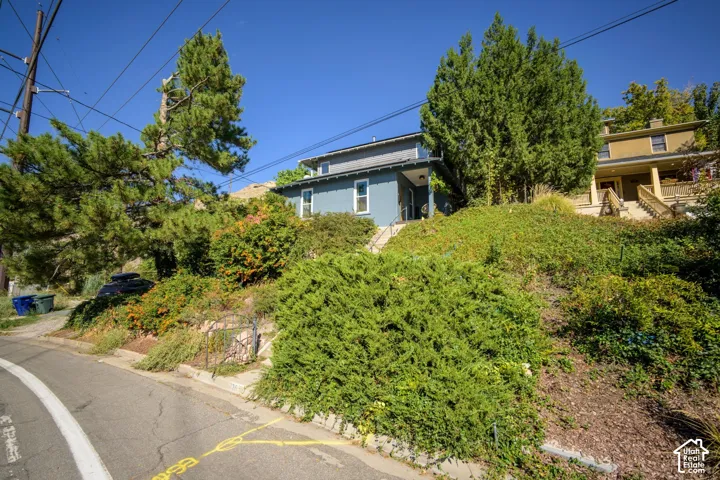 Blue exterior residence with a covered entry