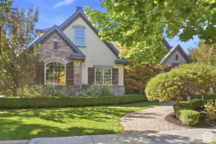 Stone and stucco exterior with gabled roof lines