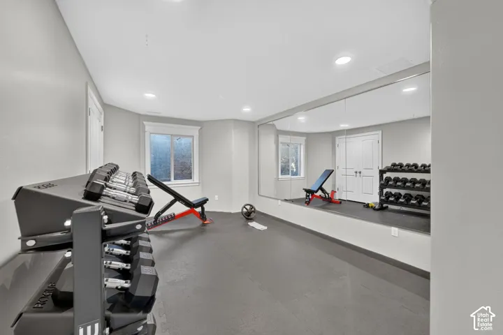 Finished interior space featuring recessed lighting, a full-wall mirror, and durable floor mats