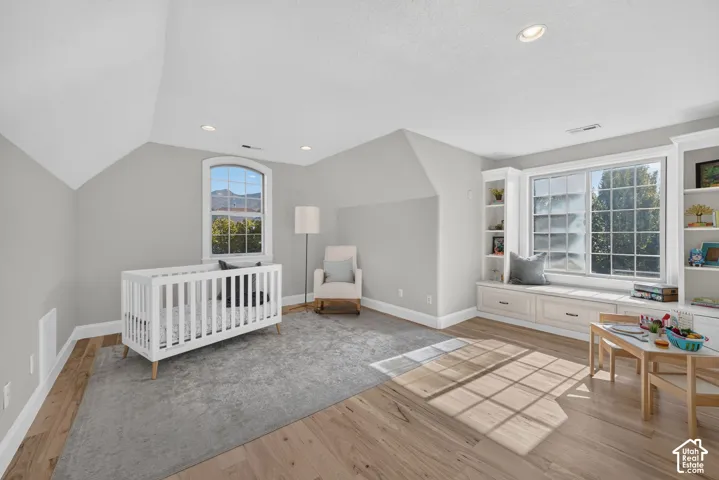 Wood-finish flooring, recessed lighting, built-in shelving, and a built-in window bench with storage drawers