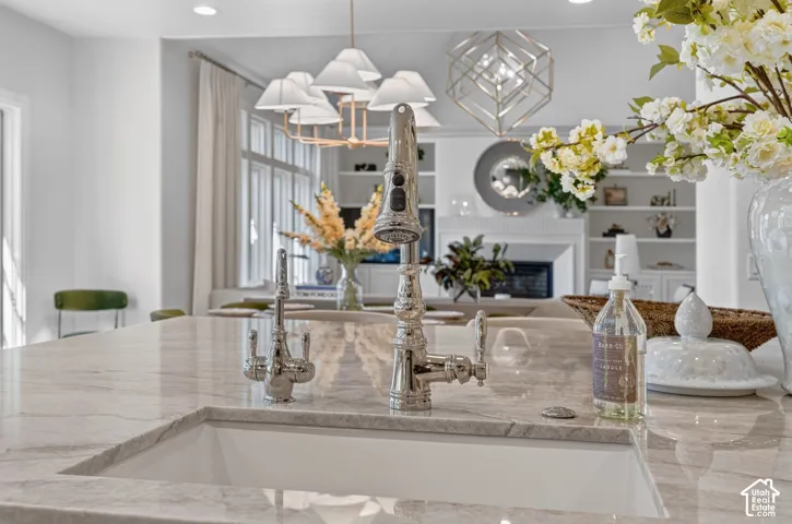 Undermount sink with a polished chrome pull-down faucet, accompanied by a secondary polished chrome faucet