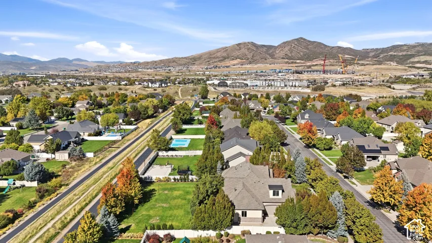 Neighborhood with mature trees, established homes, and mountain backdrop