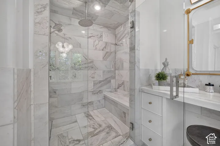 Glass-enclosed shower with multiple showerheads