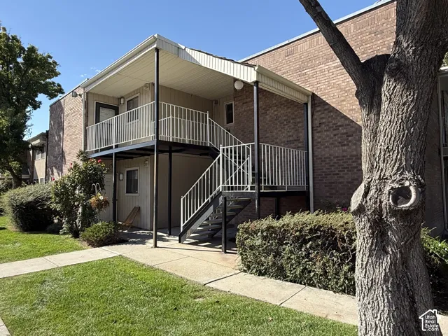 Brick exterior with white railing balconies and exterior stair access