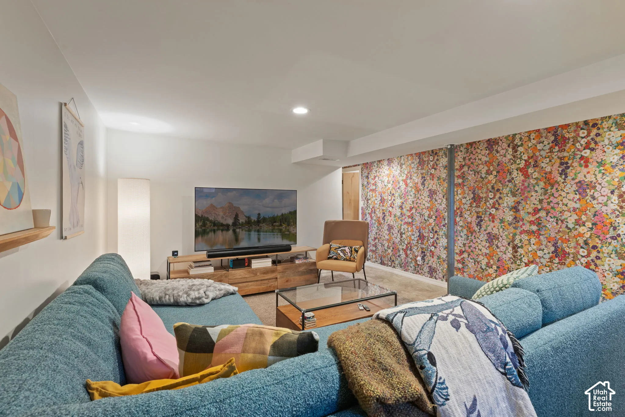Recessed lighting, wood-finish media console, and a glass-top coffee table