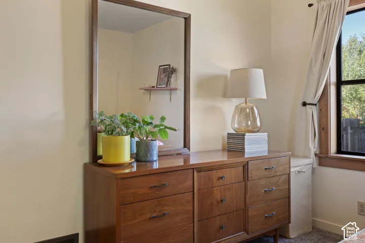 Wood-finish dresser with multiple drawers and dark hardware