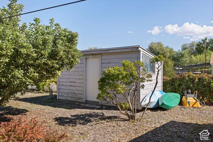 Storage shed with horizontal siding and a single window