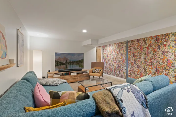 Recessed lighting, wood-finish media console, and a glass-top coffee table