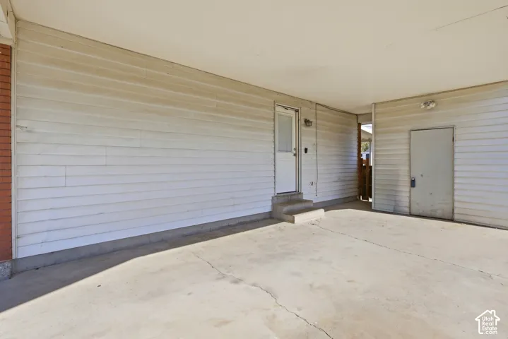 Covered concrete carport with direct entry