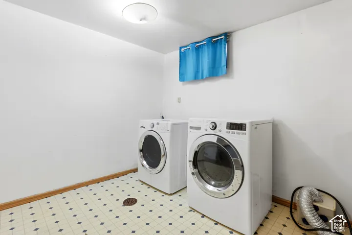 Utility room featuring patterned tile flooring and ceiling-mounted lighting