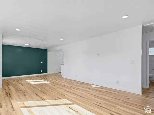 Recessed lighting, wood-finish flooring, accent wall, white walls, white trim