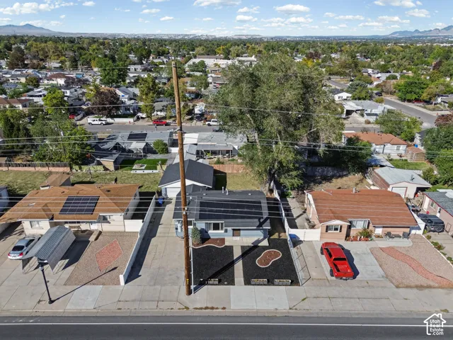 Paved driveway, mature landscaping, single-story home, pitched roof, established neighborhood setting