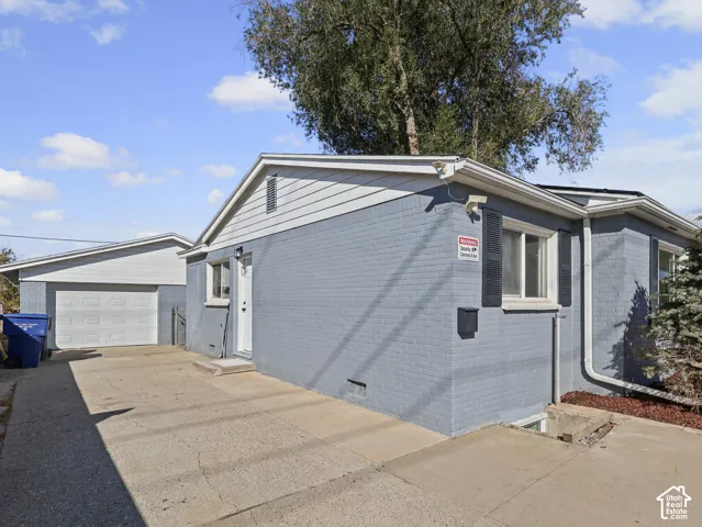 Brick exterior with a detached garage