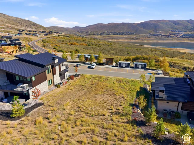 Expansive undeveloped lot with a mountainous backdrop and distant water body
