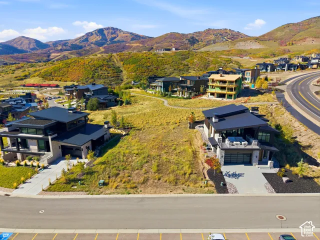 Expansive undeveloped lot situated between two modern residences, offering significant building potential within a mountainous setting