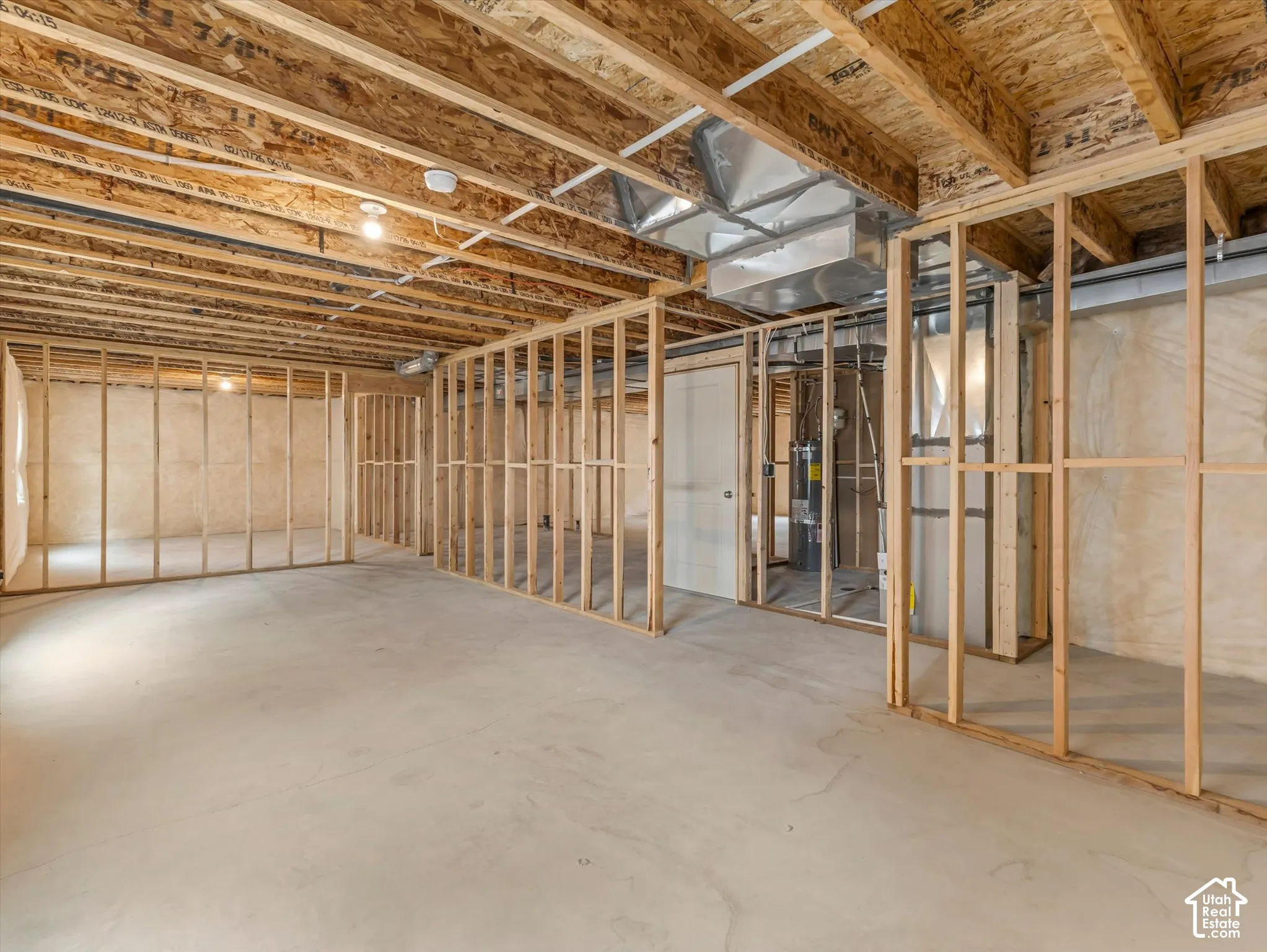 Unfinished basement featuring wood framing, concrete flooring, exposed ceiling joists, and visible ductwork