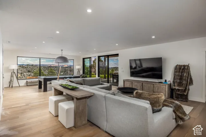 Expansive interior with light wood-finish flooring, recessed lighting, and large windows