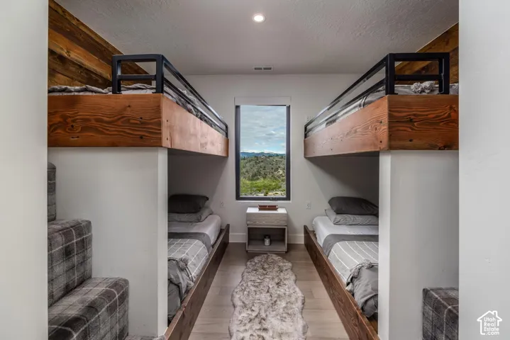 Built-in bunk beds with wood paneling and black metal railings