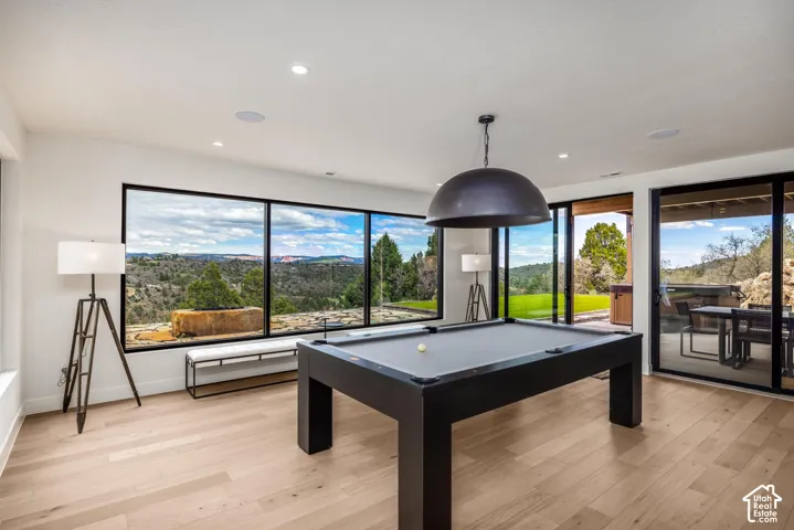Recessed ceiling lighting, light wood-finish flooring, and large sliding glass doors