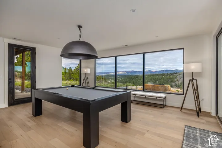 Light wood-finish flooring, recessed ceiling lighting, and expansive windows