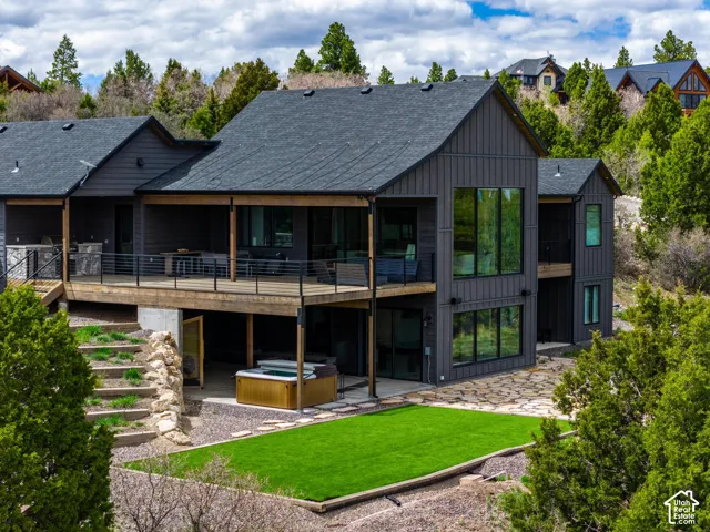 Multi-level exterior with dark vertical siding and large windows