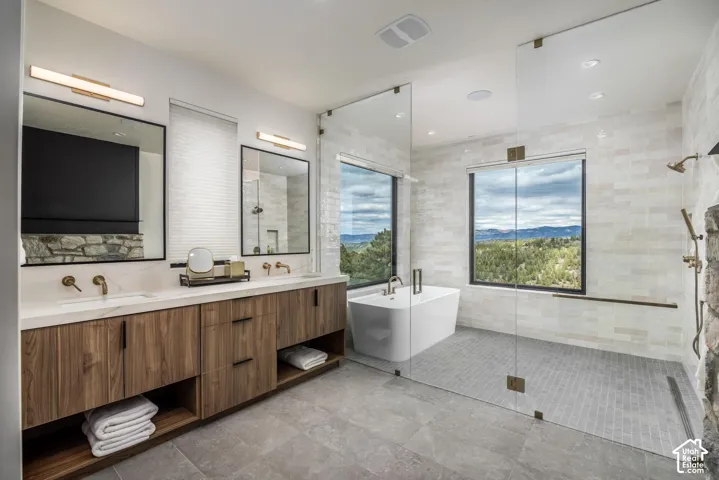 Dual floating wood-finish vanity with rectangular sinks and wall-mounted brass faucets