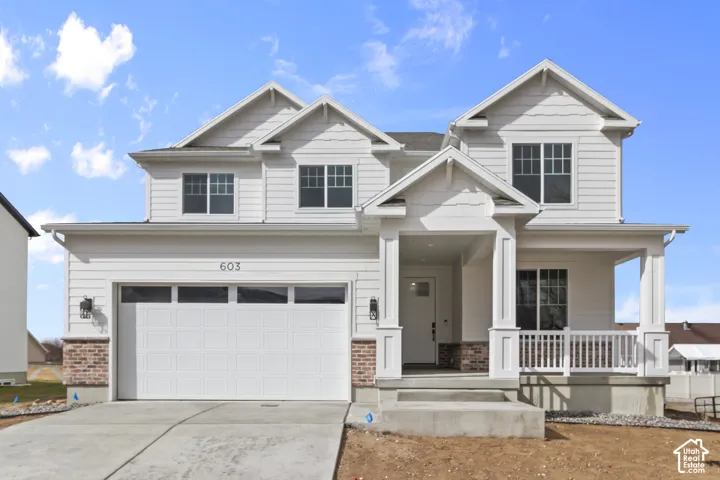 White siding exterior with a prominent two-car garage