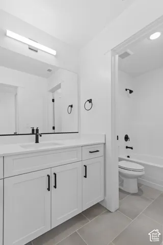 White shaker-style vanity with matte black hardware, white countertop, and integrated sink