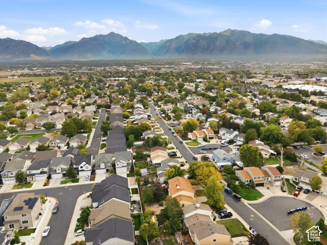 Residential neighborhood with established streets, mature trees, and mountain backdrop