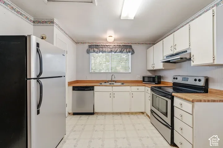 White cabinetry with wood-finish countertops