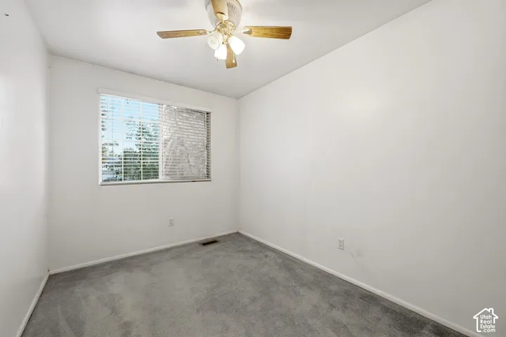 Wall-to-wall carpeting and a window with horizontal blinds