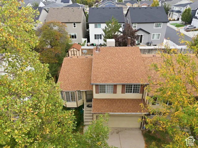Two-story exterior with a bay window, attached garage, and light-toned siding