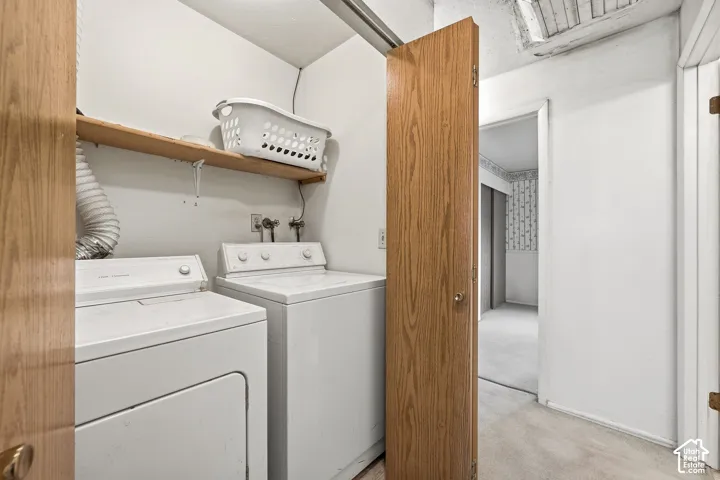 Dedicated laundry area with a wood-finish shelf