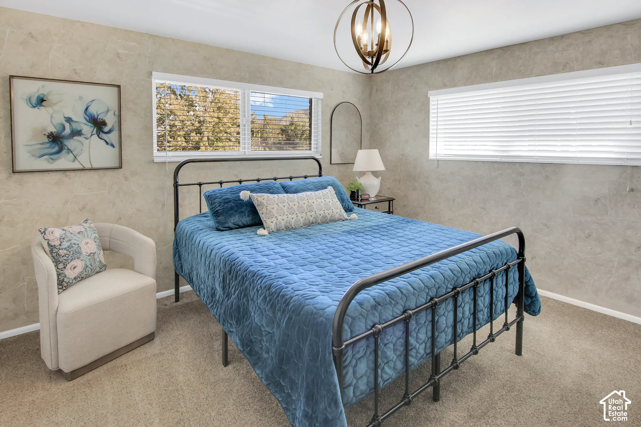 #1 Bedroom Carpeted room with multiple windows, a decorative overhead light fixture, and textured wall coverings
