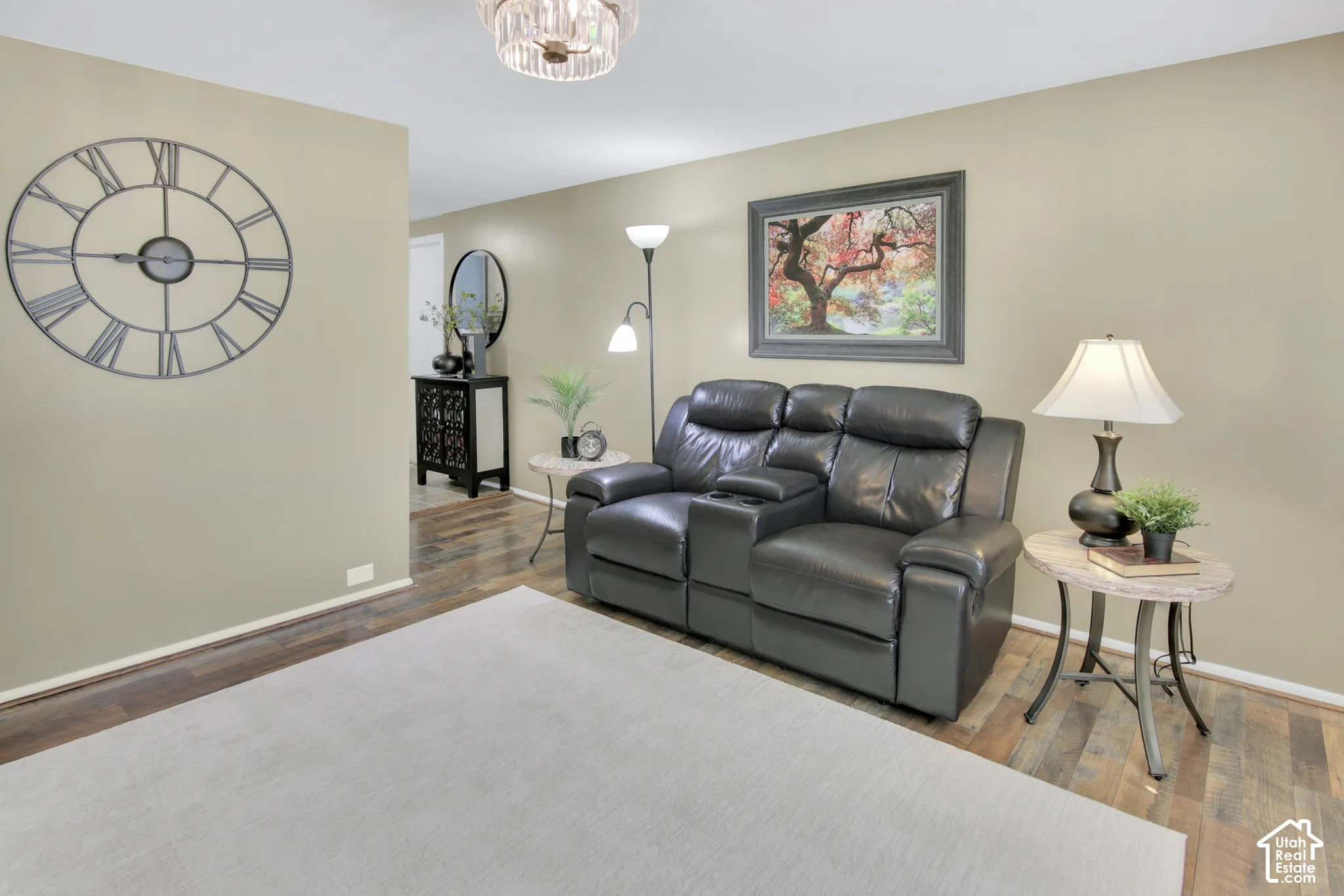 Recessed lighting, wood-finish flooring, and a decorative ceiling fixture