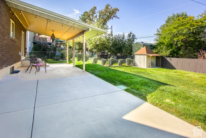 Expansive concrete patio with a covered awning