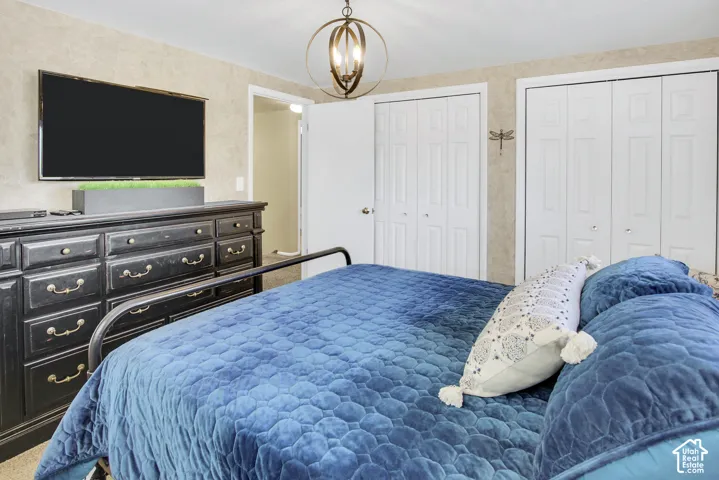 #1 Bedroom Textured wall covering, closet doors, and recessed lighting