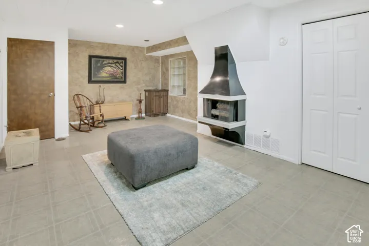 Tile flooring with a light gray finish, featuring cute nooks, wall bookcase and storage room