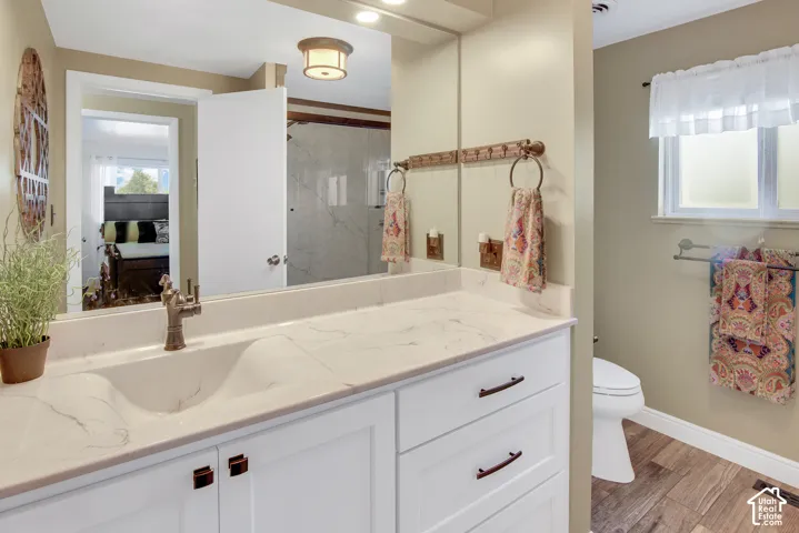 Expansive vanity with integrated sink, white cabinetry, and bronze-finish hardware