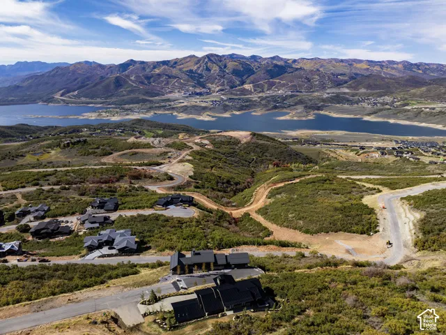 Expansive natural landscape with a prominent lake and surrounding mountains
