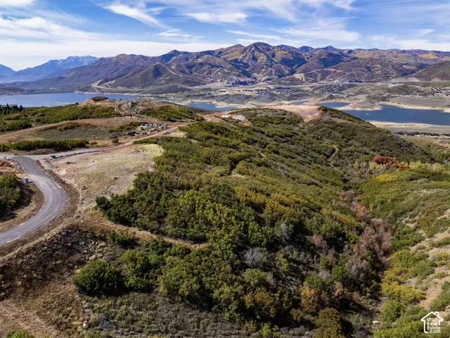 Expansive land parcel featuring distant mountain ranges, multiple reservoirs, and varying terrain with natural vegetation