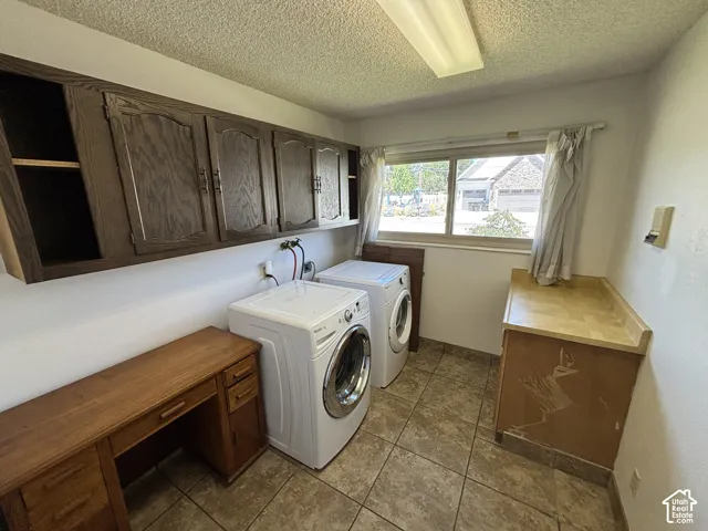 Tile flooring complemented by upper cabinetry, a built-in desk, and a utility counter