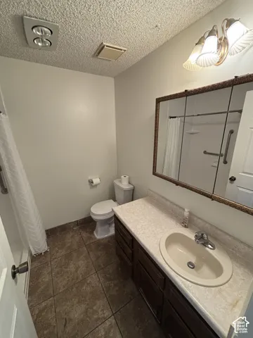 Bathroom featuring a vanity with an integrated sink, a three-light sconce, and a framed medicine cabinet
