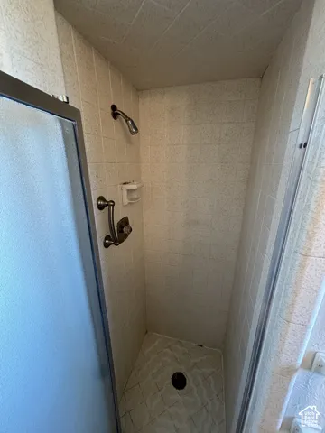 Tiled shower enclosure with a clear glass door
