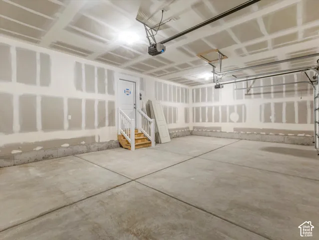 Concrete flooring, drywall-finished walls, and ceiling-mounted lighting